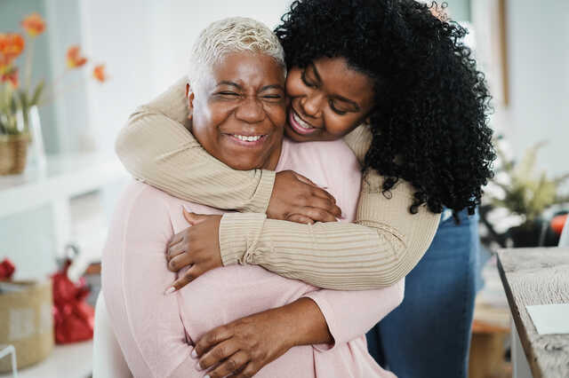 grown woman hugging her mother
